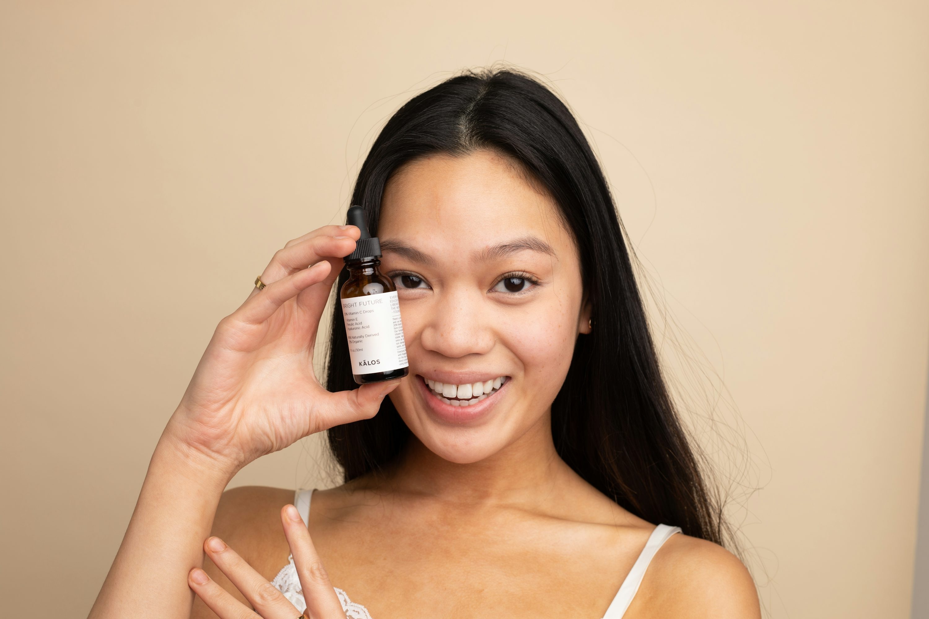 Woman applying skincare products in a bright bathroom